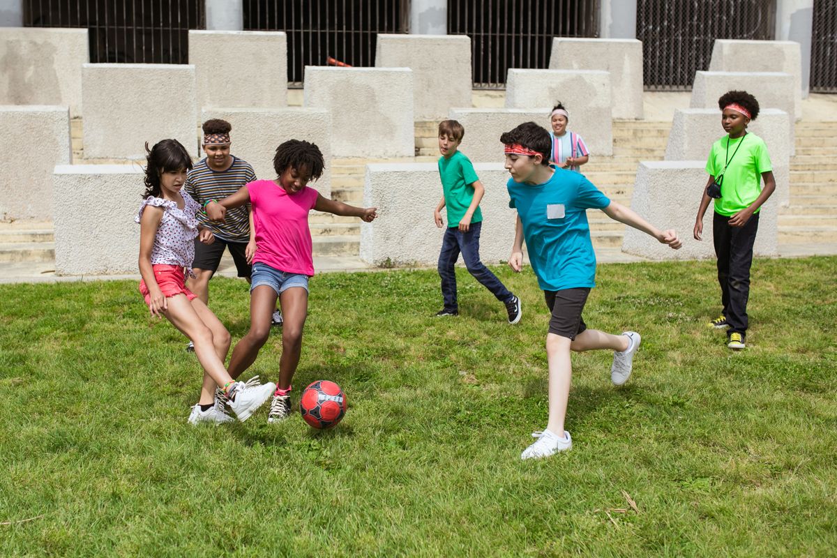 Children playing a youth soccer game together